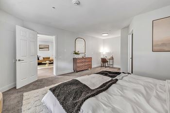 A bedroom with a large bed and a rug on the floor at The Meriden, Meriden